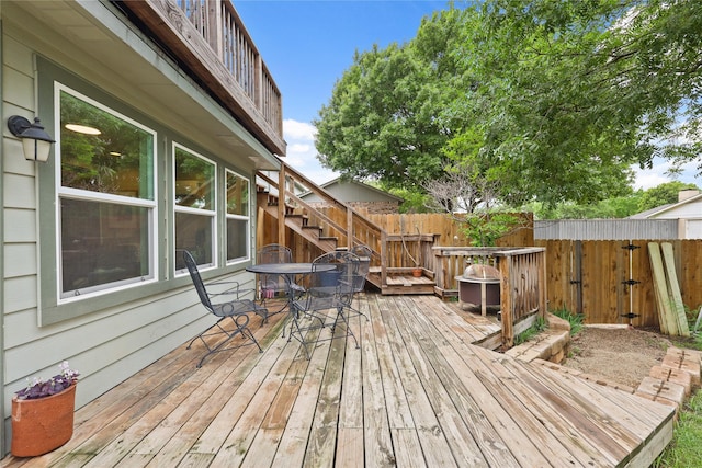 deck featuring fence, stairs, and outdoor dining space