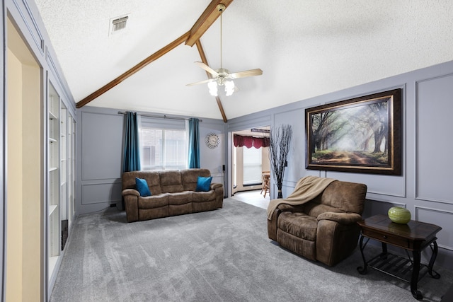 carpeted living room featuring ceiling fan, a decorative wall, a textured ceiling, vaulted ceiling with beams, and visible vents