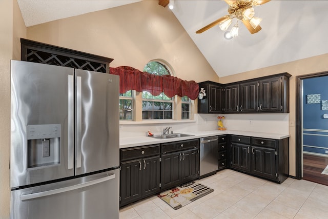 kitchen featuring dark cabinets, lofted ceiling with beams, appliances with stainless steel finishes, and light countertops