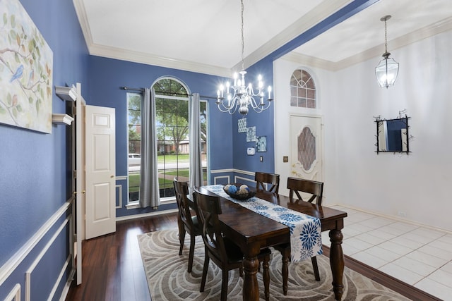 dining room with dark wood-style floors, a notable chandelier, and ornamental molding
