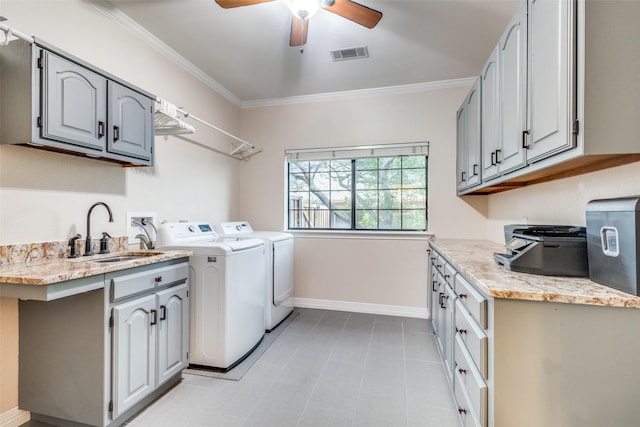 laundry room with washing machine and clothes dryer, crown molding, a sink, a ceiling fan, and visible vents
