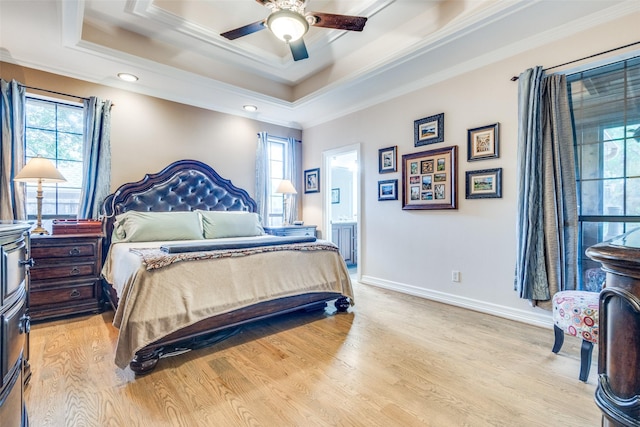 bedroom featuring light wood-style floors, ornamental molding, and multiple windows