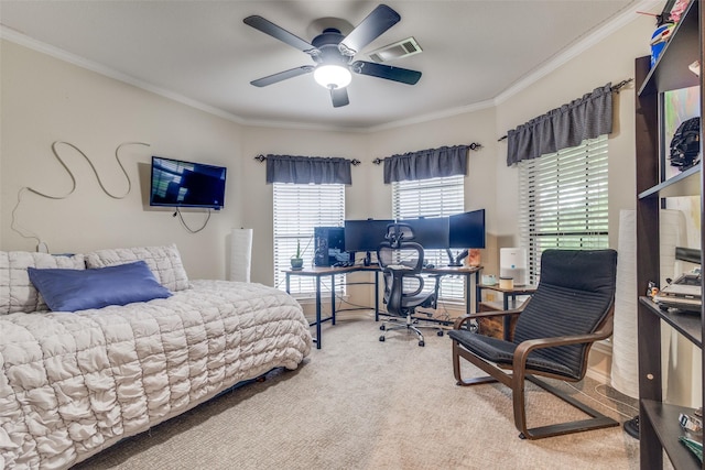 carpeted bedroom with crown molding, a ceiling fan, and visible vents