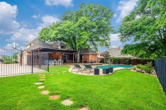 view of yard featuring a fenced in pool, a fenced backyard, and a patio