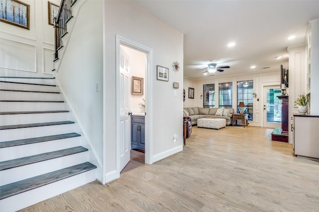 living room with ceiling fan, stairway, ornamental molding, recessed lighting, and light wood-style flooring