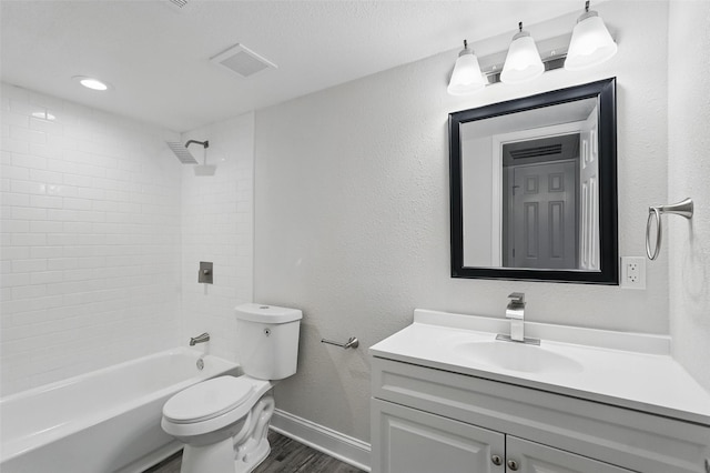full bathroom with vanity, toilet, baseboards, wood finished floors, and visible vents