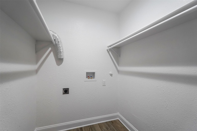 clothes washing area featuring washer hookup, laundry area, dark wood-style flooring, electric dryer hookup, and baseboards