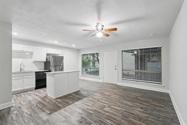 kitchen with freestanding refrigerator, ceiling fan, white cabinetry, a sink, and dishwasher