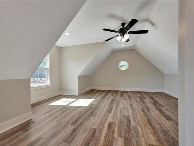 bonus room with plenty of natural light, wood finished floors, and lofted ceiling