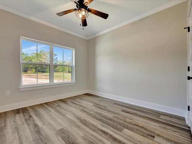 empty room with crown molding, baseboards, ceiling fan, and wood finished floors
