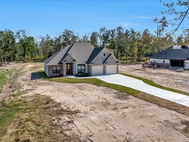 view of front of property with concrete driveway and brick siding