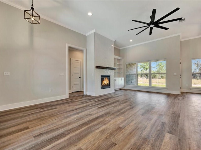 unfurnished living room featuring ceiling fan, baseboards, and wood finished floors