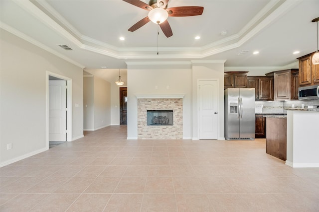 unfurnished living room featuring a raised ceiling, a ceiling fan, light tile patterned flooring, and visible vents