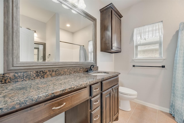 bathroom with tile patterned flooring, curtained shower, baseboards, vanity, and toilet