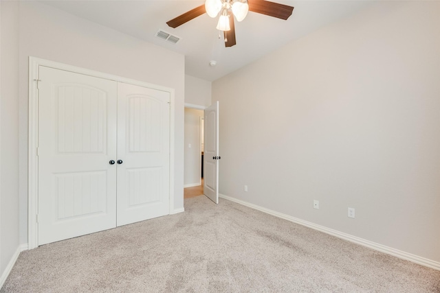 unfurnished bedroom with visible vents, a closet, baseboards, a ceiling fan, and carpet