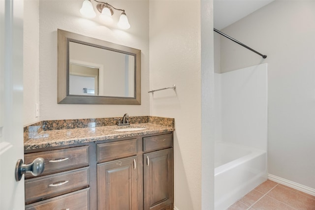 full bath featuring vanity, baseboards, tile patterned floors, and shower / bathing tub combination