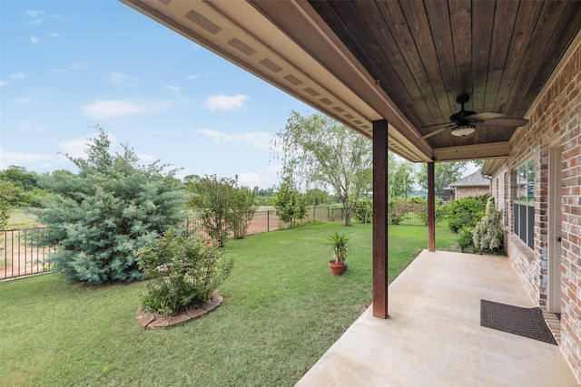 view of yard featuring a patio, ceiling fan, and a fenced backyard