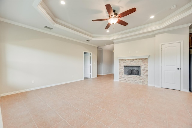 unfurnished living room with crown molding, a ceiling fan, visible vents, and a raised ceiling