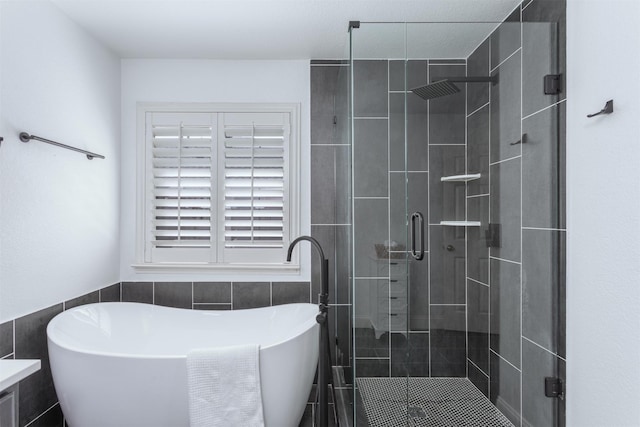 4045 Sun King Ln, Frisco, TX 75033 - bathroom featuring a freestanding tub, tile walls, and a stall shower