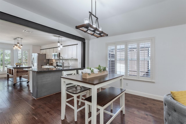 4045 Sun King Ln, Frisco, TX 75033 - dining room with baseboards, a notable chandelier, dark wood-style floors, and visible vents