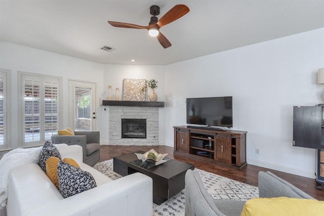 4045 Sun King Ln, Frisco, TX 75033 - living room featuring visible vents, wood finished floors, a fireplace, baseboards, and a ceiling fan