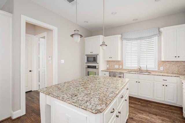 2231 Morning Dew Ct, Allen, TX 75013 - kitchen featuring a sink, appliances with stainless steel finishes, dark wood finished floors, decorative backsplash, and white cabinetry