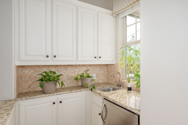 2231 Morning Dew Ct, Allen, TX 75013 - kitchen featuring a sink, tasteful backsplash, white cabinetry, and light stone counters