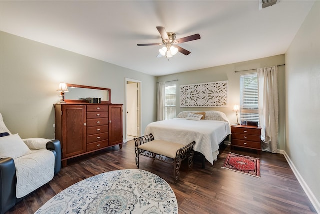 bedroom with baseboards, a ceiling fan, dark wood-style flooring, and visible vents