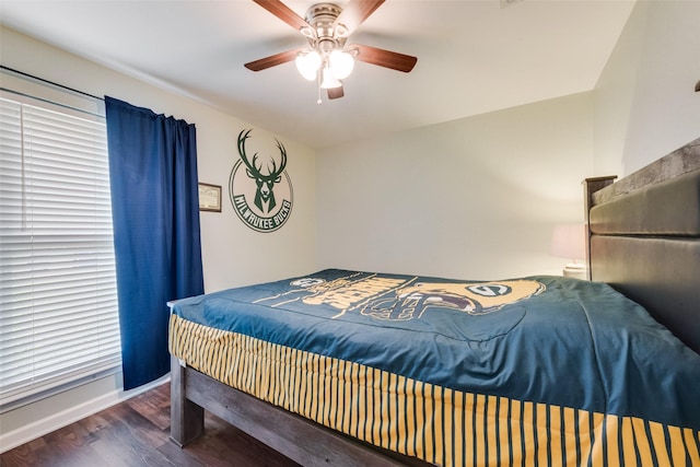 bedroom featuring baseboards, ceiling fan, and wood finished floors
