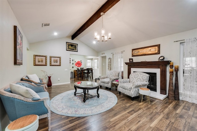 living area featuring vaulted ceiling with beams, visible vents, wood finished floors, and a chandelier