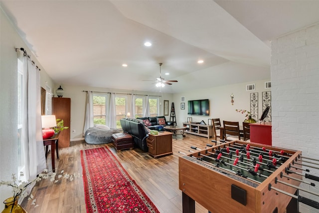 recreation room featuring visible vents, wood finished floors, recessed lighting, a ceiling fan, and vaulted ceiling