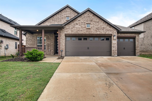 5608 Crestview Dr, Celina, TX 75009 - french country inspired facade featuring a porch, brick siding, a front lawn, concrete driveway, and an attached garage