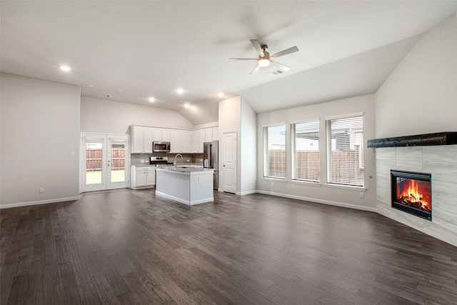 5608 Crestview Dr, Celina, TX 75009 - unfurnished living room featuring ceiling fan, a fireplace, baseboards, dark wood-type flooring, and vaulted ceiling