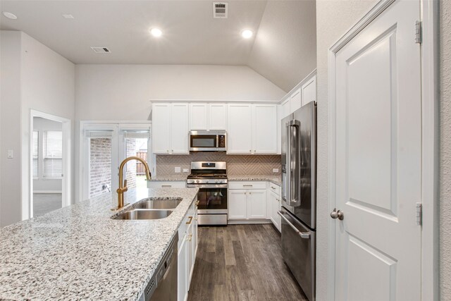 5608 Crestview Dr, Celina, TX 75009 - kitchen with visible vents, appliances with stainless steel finishes, vaulted ceiling, dark wood finished floors, and a sink