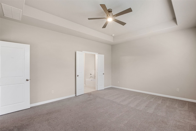 5608 Crestview Dr, Celina, TX 75009 - unfurnished bedroom with visible vents, carpet floors, baseboards, ensuite bathroom, and a tray ceiling