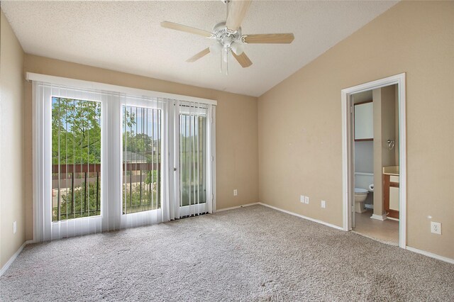 unfurnished bedroom with carpet flooring, baseboards, and vaulted ceiling