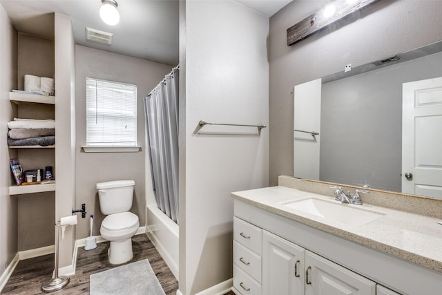 bathroom featuring visible vents, wood finished floors, toilet, and vanity