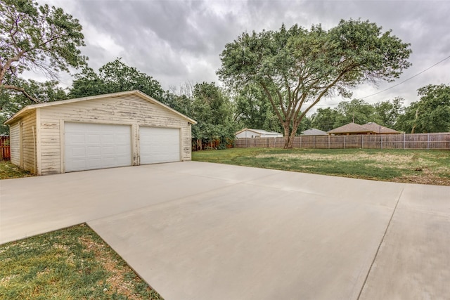 detached garage featuring fence