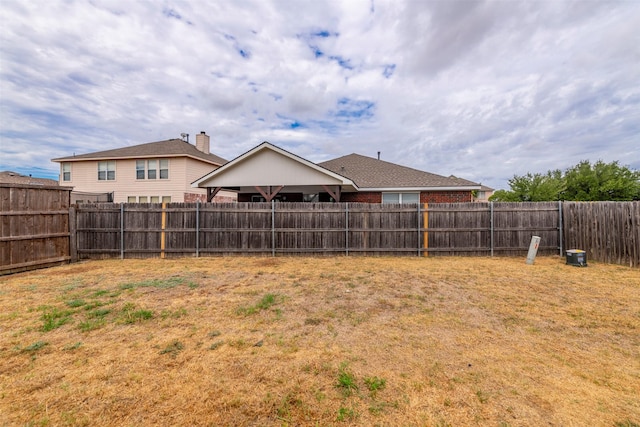 view of yard with a fenced backyard