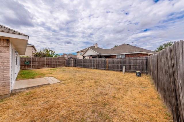 view of yard with a fenced backyard and a patio area