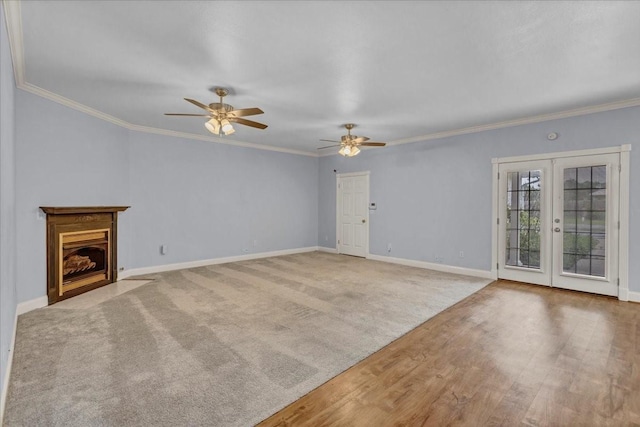 unfurnished living room with french doors, baseboards, crown molding, and a ceiling fan