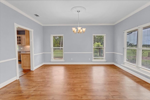 unfurnished dining area with a healthy amount of sunlight, light wood finished floors, and a chandelier