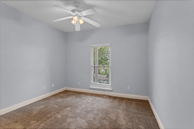 carpeted empty room with baseboards and ceiling fan