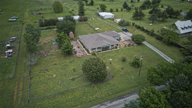 birds eye view of property with a rural view