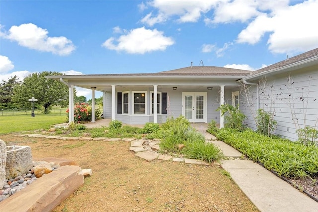 exterior space with french doors and a front lawn
