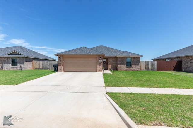 view of front of house featuring concrete driveway, a front yard, and brick siding