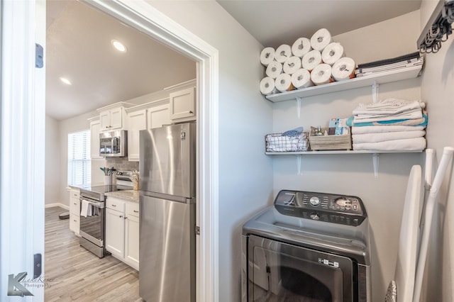 laundry area with laundry area, washer / dryer, baseboards, recessed lighting, and light wood finished floors