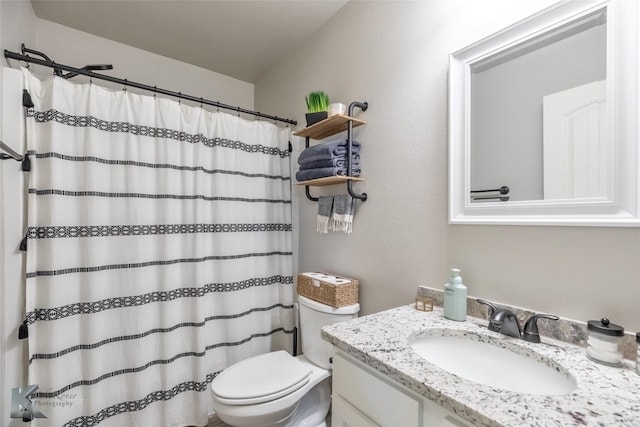 bathroom featuring toilet, a shower with shower curtain, and vanity