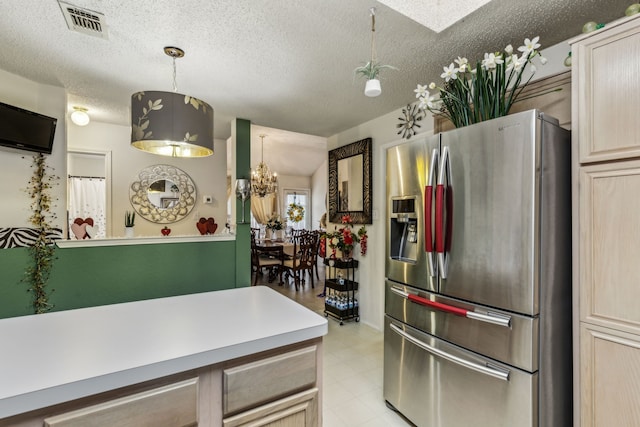 kitchen with visible vents, pendant lighting, light countertops, a textured ceiling, and stainless steel fridge with ice dispenser