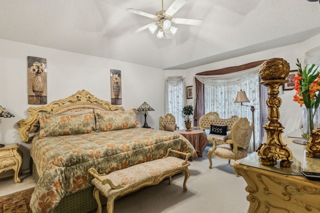 carpeted bedroom with a ceiling fan, a textured ceiling, and vaulted ceiling